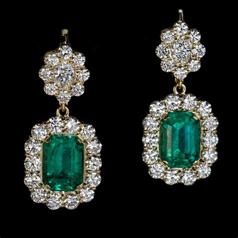Antique emerland earrings 40 carats set in halo setting Total diamonds in earrings weighing 1